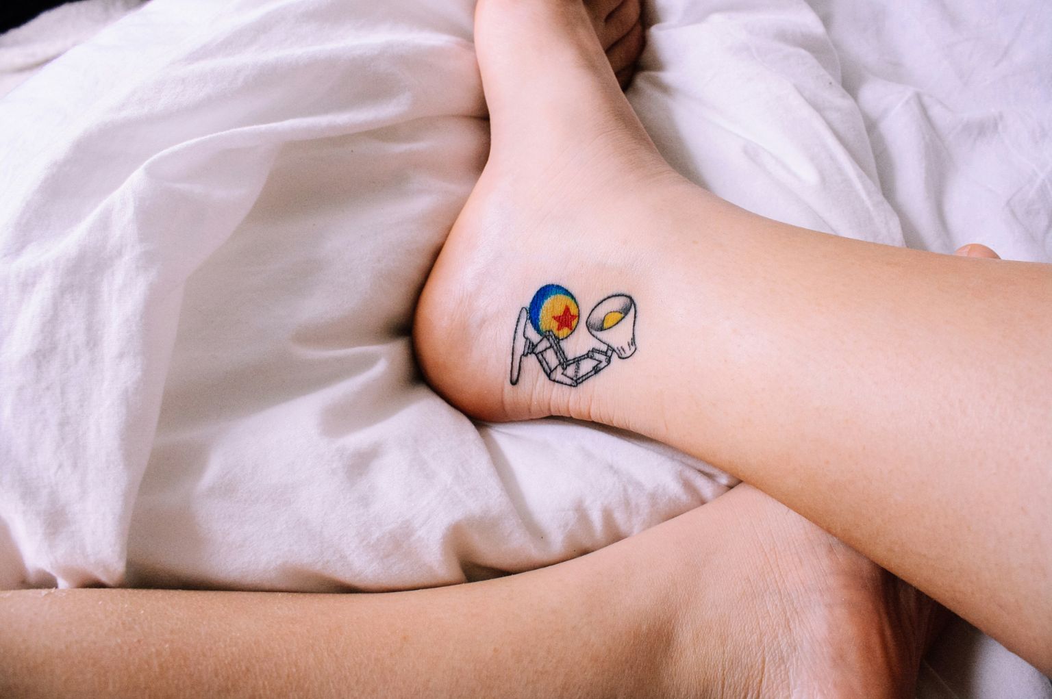 Photo of an ankle with a Pixar's lamp tattoo